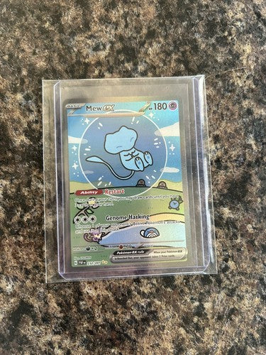 Pokémon trading card in protective packaging on a granite surface