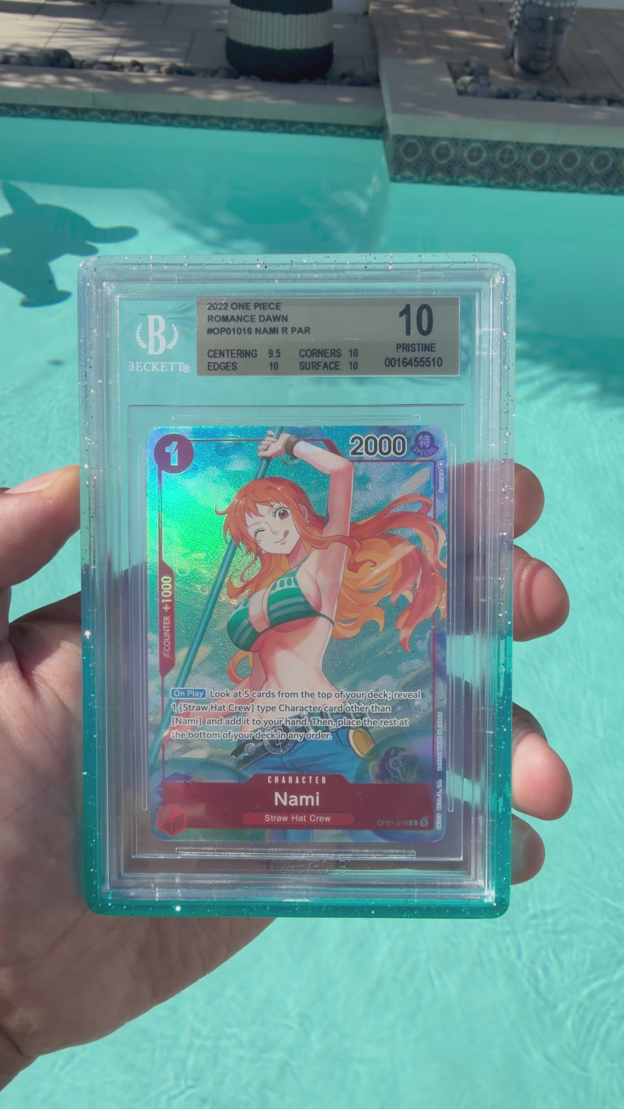 Load video: 2022 One Piece OP01 Nami Alt Art Alpha PRE-ERRATA BGS Pristine 10 Gold Label